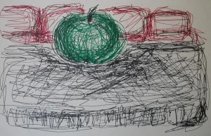 Apple on table with sofa behind it
